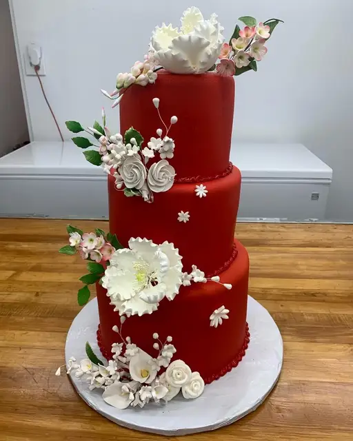 Red tiered cake with sugar flowers