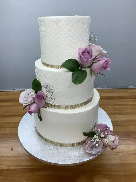 Three-tier white cake with sugar flowers